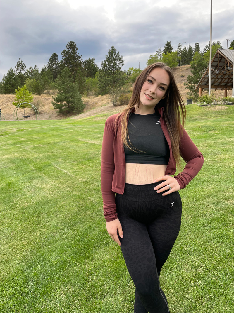 A picture of the coach posing in front of the camera in a field
